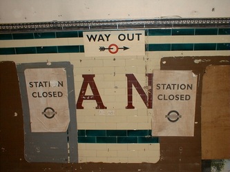 Station closed and way out signs on platform inside disused Aldwych Underground Station