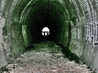Dark abandoned railway tunnel leading to the defunct Highgate station