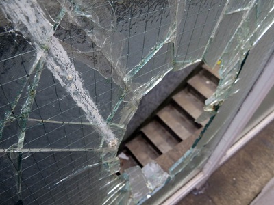 broken glass of smashed window in public London toilets