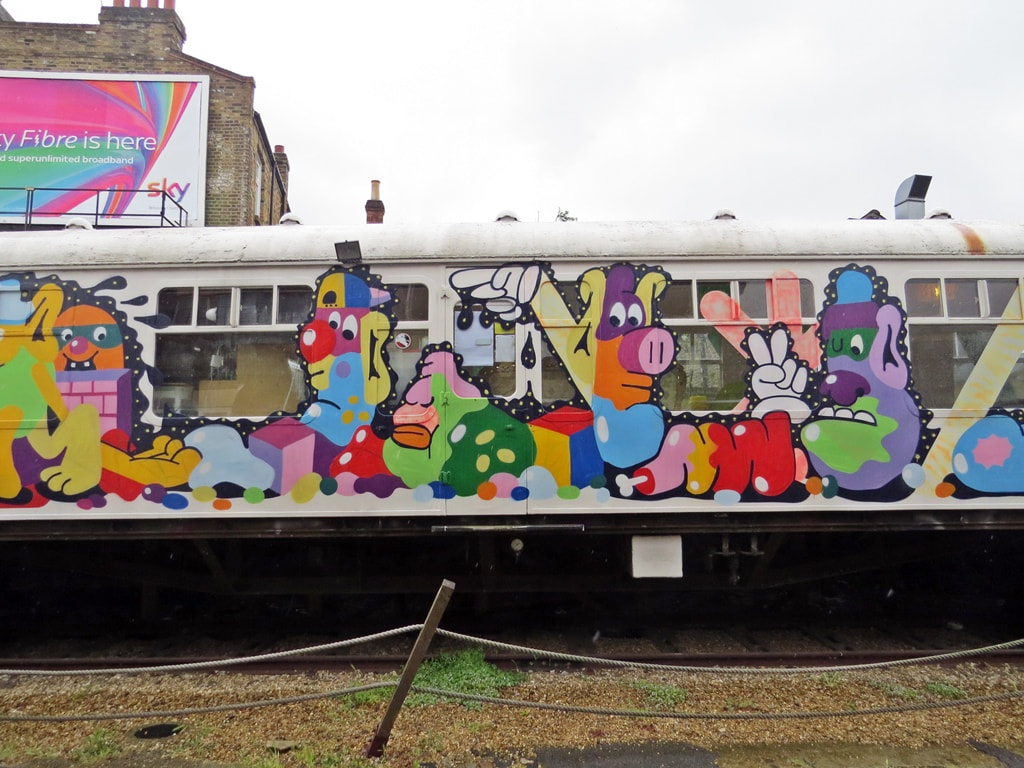 Train carriage covered in  street art now a café in Deptford, South London