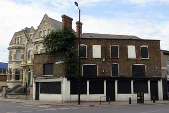 The Coach & Horses on the High St closed down and derelict. Another of London's abandoned pubs