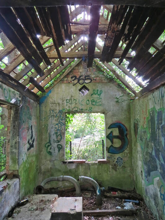 Picture of roofless and derelict graffiti covered small building that was once a pump house for transferring water from Ruislip Lido to a nearby golf course