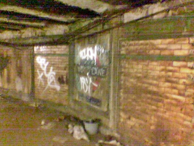 Tiled interior showing Wood Lane roundel on disused underground station
