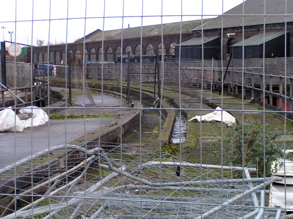 Looking through the fence at neglected rail yards at Kings Cross in 2003
