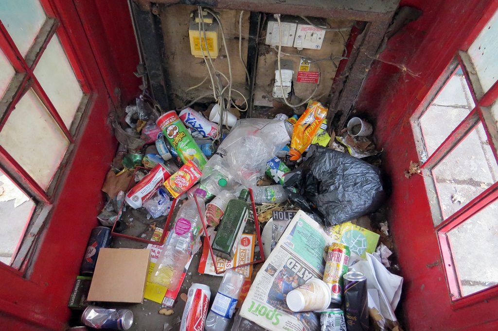 Litter in disused red K2 phone booth in London