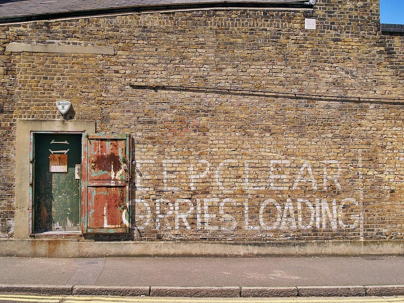 Clapton: Keep Clear Lorries Loading painted on brick wall