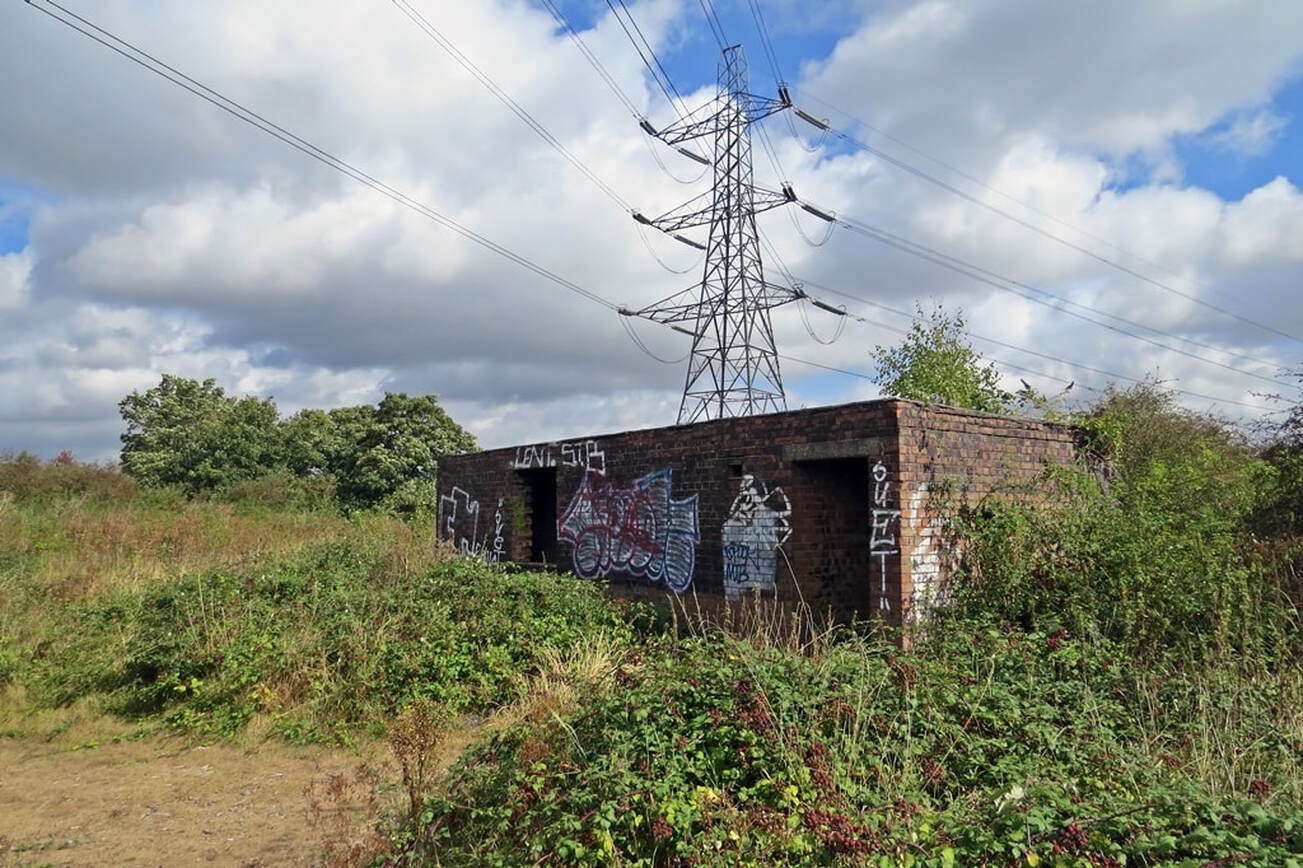 Pylons and derelict buildings on site of former Orchard Hospital on Joyce Green Lane in Dartford, DA1