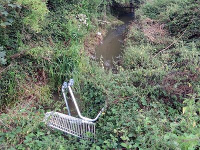 abandoned shopping trolley in the Pymmes Brook in New Barnet, North London