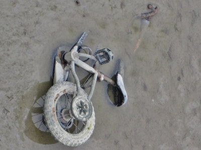 Abandoned child's bike in the River Thames in Woolwich, SE London
