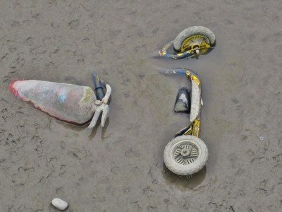 stolen child's toy scooter and fire extinguisher on the Thames foreshore in SE London