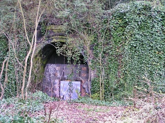 Highgate station in a deep cutting with tunnels at each end.
