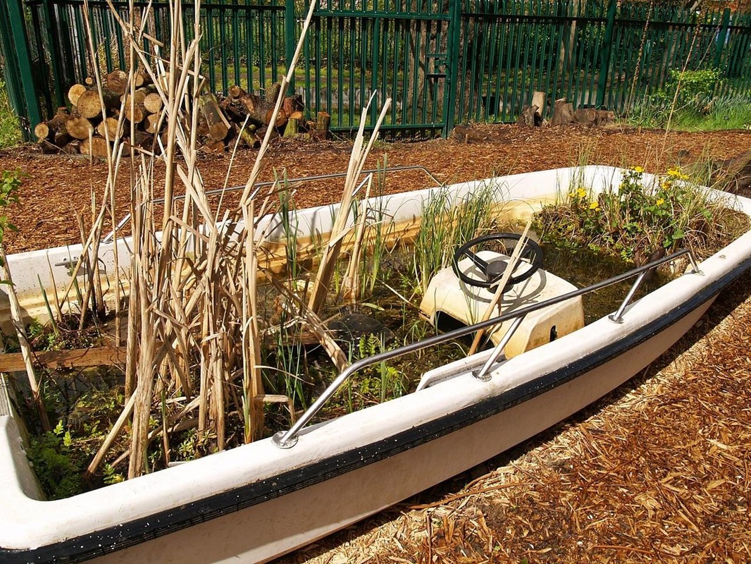 Picture disused pleasure boat now a flower bed in Stoke Newington