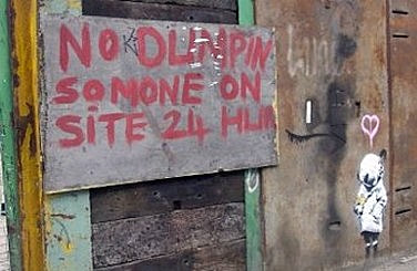 original Banksy stencil next to the 'No Dumpin' sign in Deptford, South London