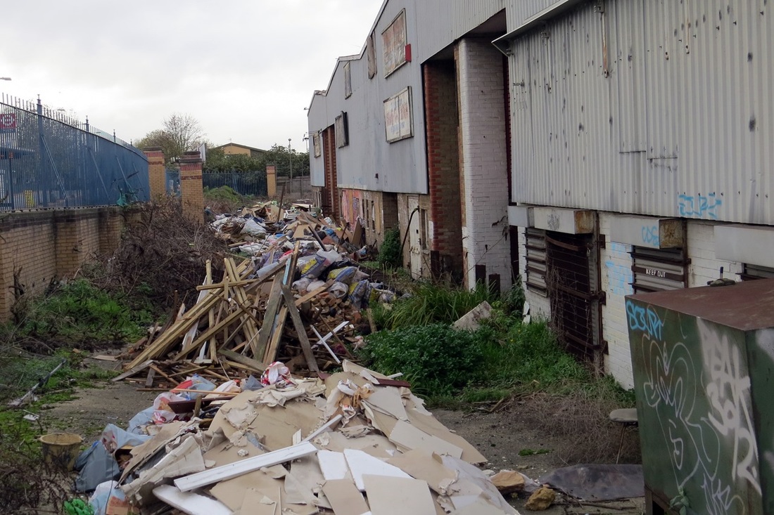Picture of rubbish beside abandoned warehouse in South East London