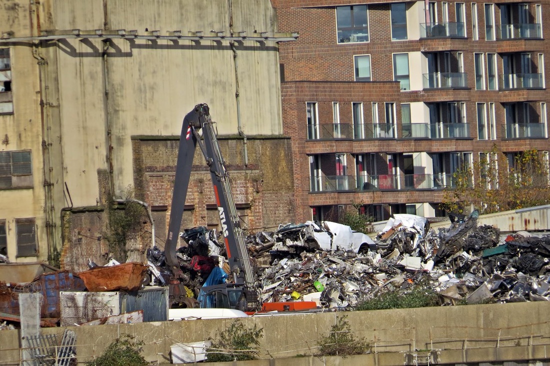 Picture of scrap metal works on industrial site next to new build flats in Silvertown, E16