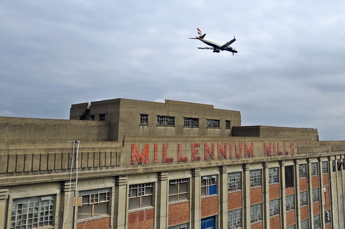 Picture of London City Airport jet above the Millenium Mills at Royal Victoria Dock