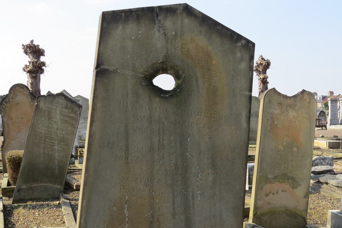 damaged headstones in East Ham Jewish Cemetery which he believes to be shrapnel damage or bullet holes from a dogfight