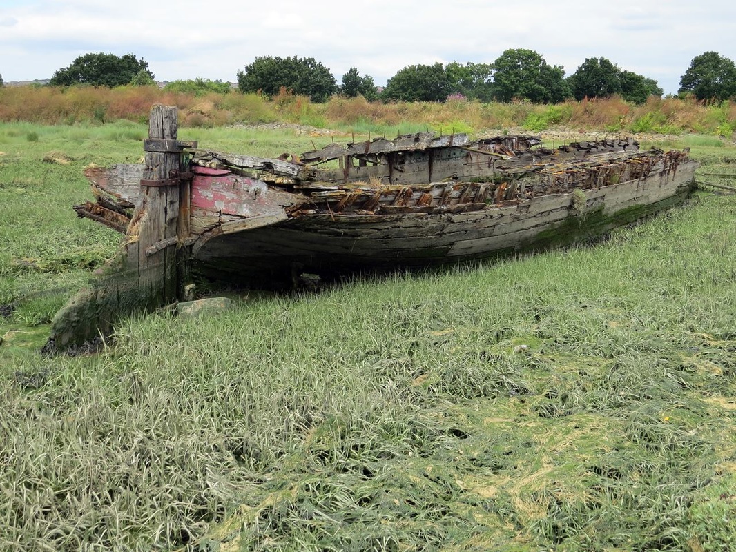 Picture of decayed wreck of a sailing barge hulked near Hoo Marina on the River Medway in Kent. 
