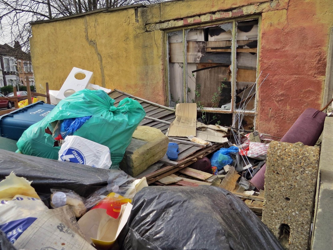 Piles of rubbish abandoned and dumped in Croydon yard