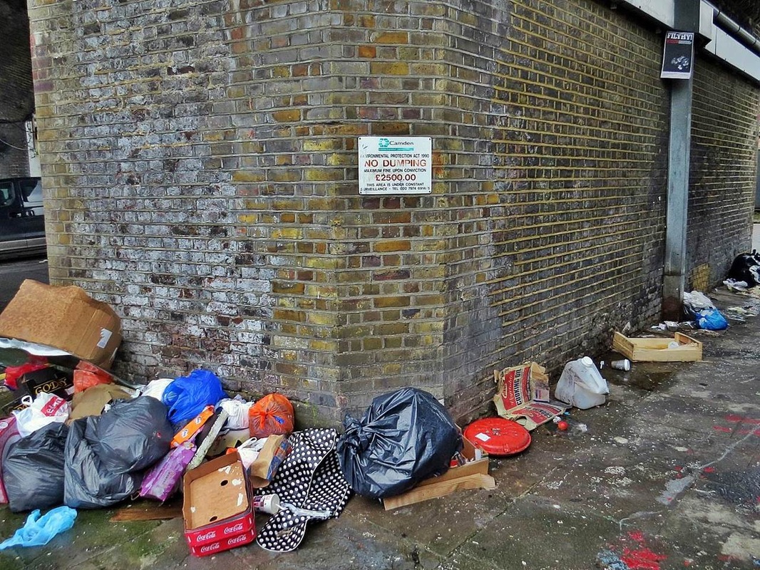 Flytipping underneath No Dumping sign in Camden Town