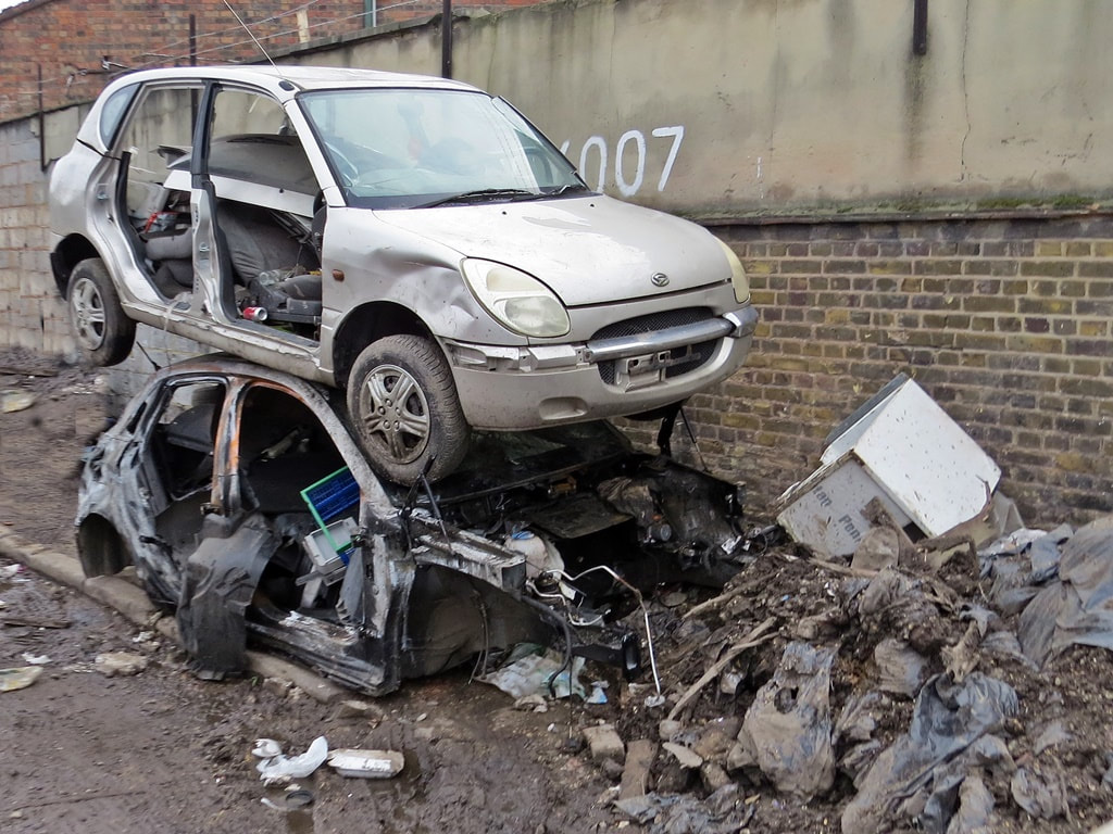 Picture of wrecked cars abandoned by the roadside in East London