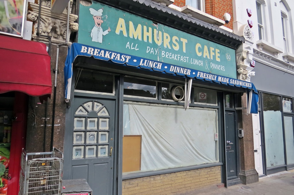 Closed down Amhurst Cafe with canopy advertising breakfast, lunch, dinner and freshly made sandwiches in Hackney, E8 