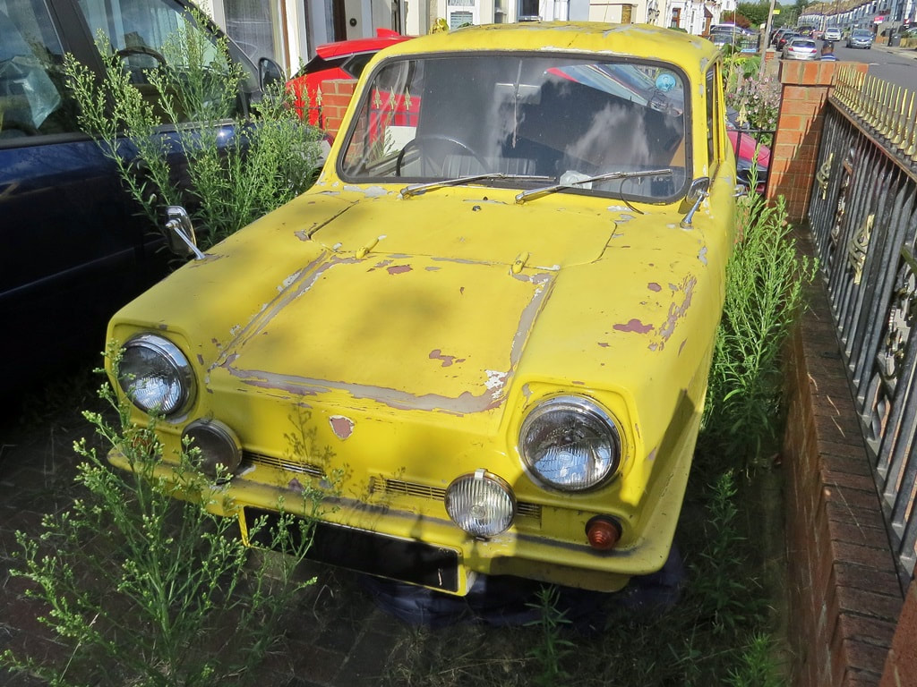 Only Fools and Horses. Yellow derelict Robin Reliant in South london