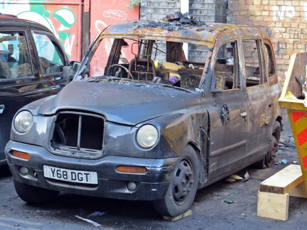 Fire damaged iconic black London Taxi in East London