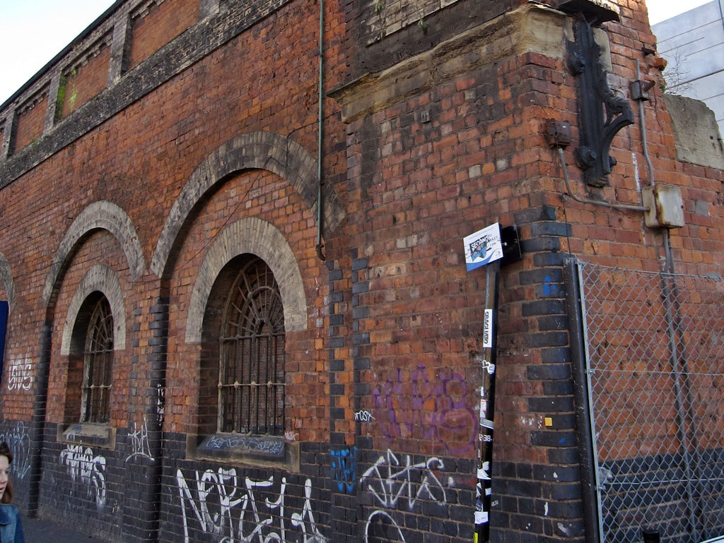 Decaying remains of brick walls and arches of the Bishopsgate Goodsyard