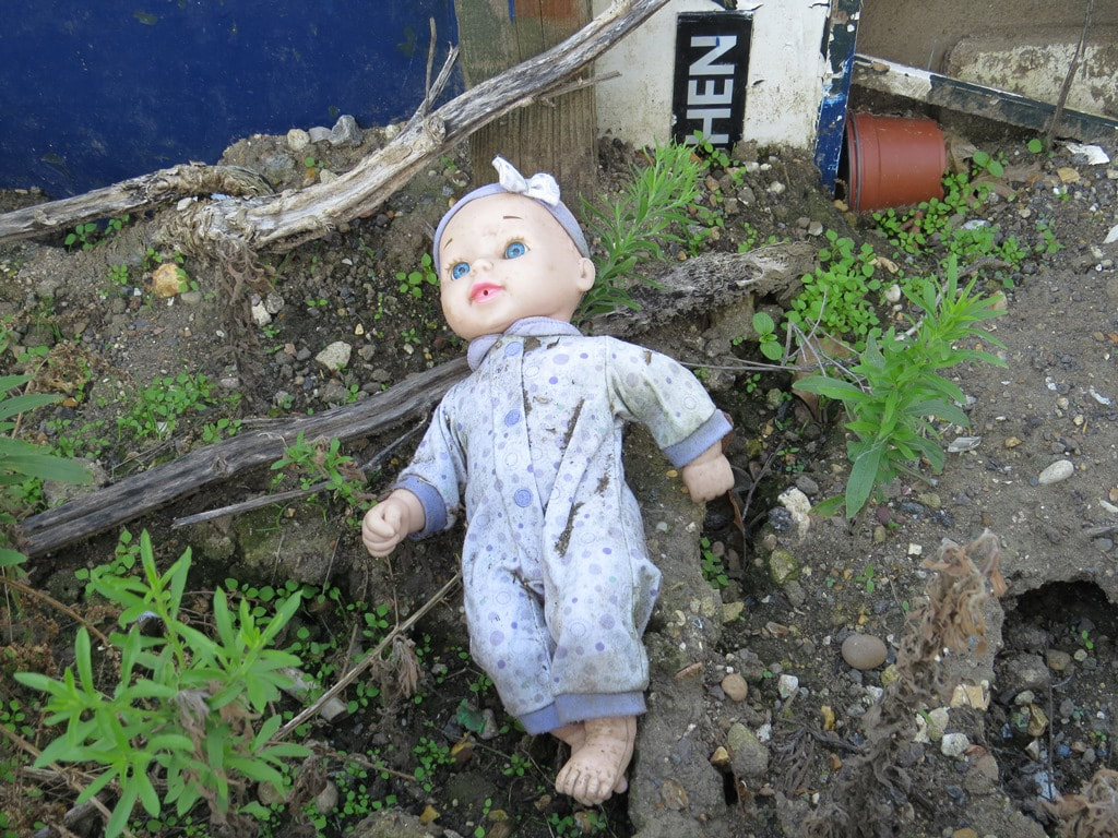 Abandoned child's doll at the back of the Bitter End derelict gig venue and pub in Romford, East London