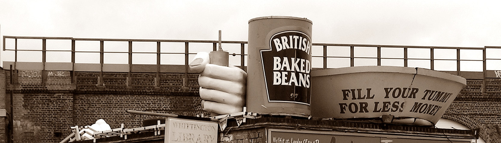 Giant Heinz Baked Bean Tin on top of a cafe near Brixton with a sign that says Fill Your Tummy for Less Money