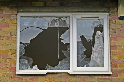 broken window and crime on derelict East London housing estate