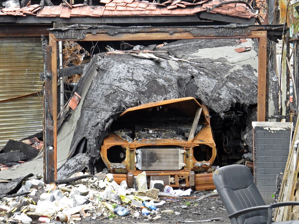 Burnt out car after fire at ​Imperials Prestige Used Cars in  Chadwell Heath,Romford. RM6