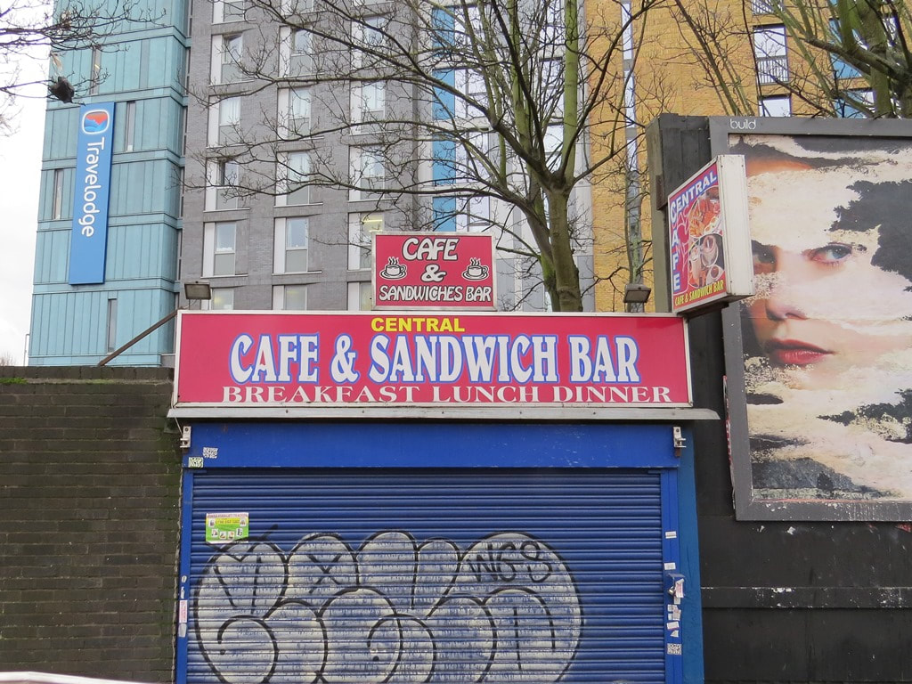 Closed down cafe with graffiti on shutters in Walthamstow, East London