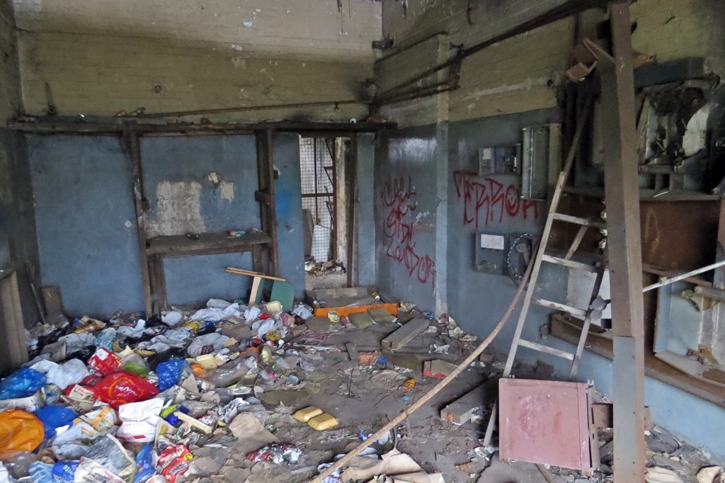 flytipping and squatters' rubbish left in derelict building in East London
