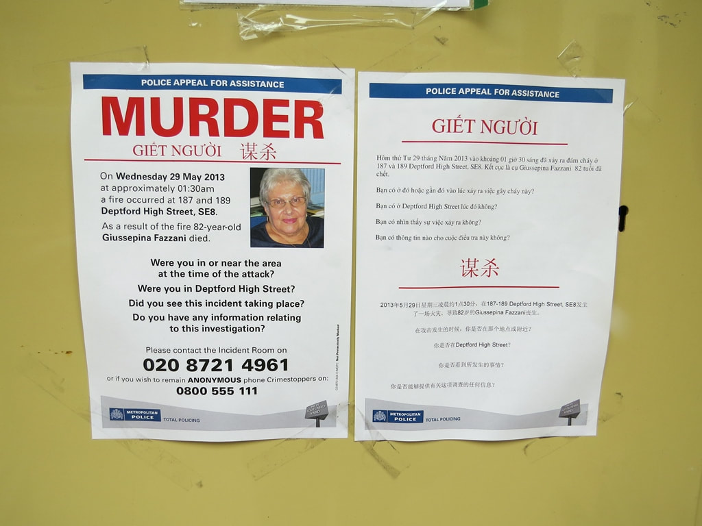 Police Murder Appeal posters in English and Vietnamese  on boarded up cafe on Deptford High Street after person died in a fire