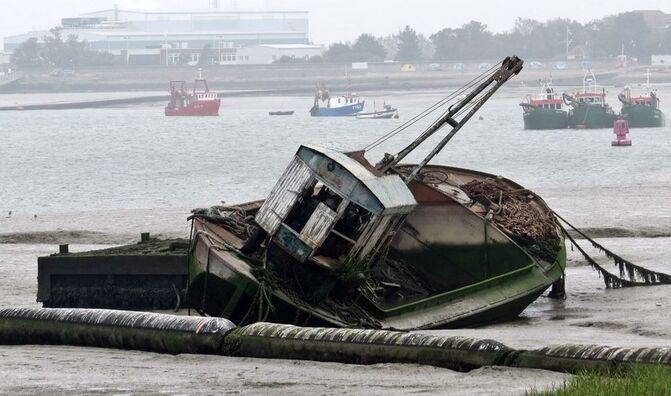 Picture of abandoned boat at Queenborough on Isle of Sheppey,Kent  beside boat breakers yard once served by railway sidings 