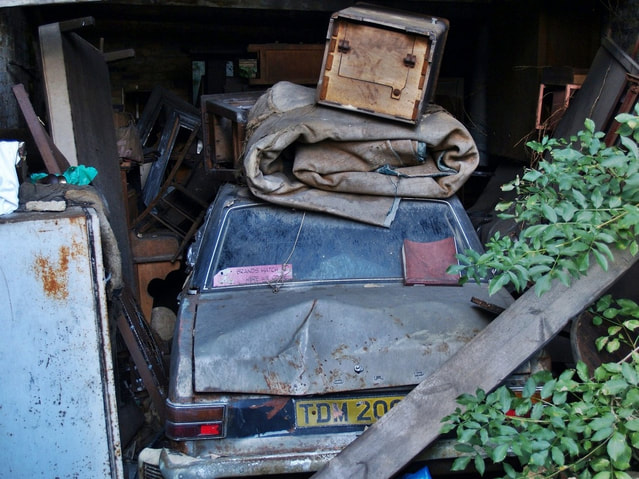 decaying Ford Cortina Mark 2 in abandoned garage in Clapham