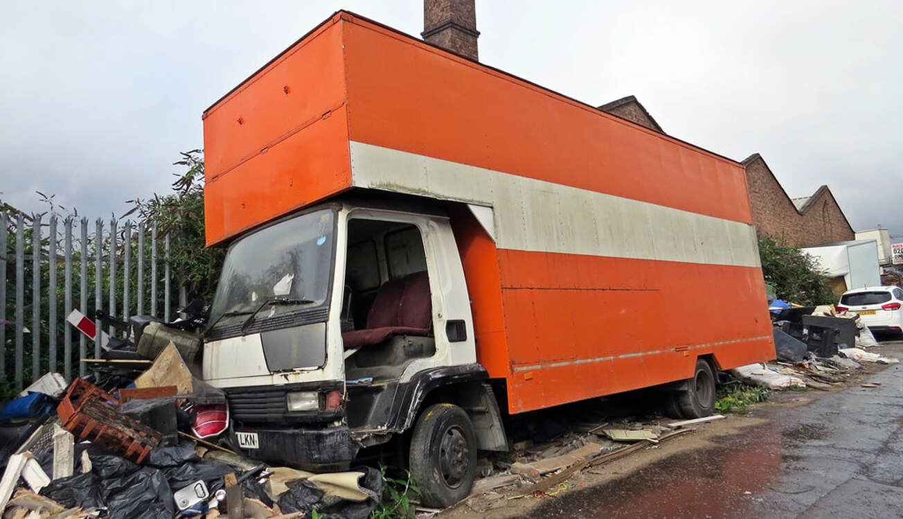 Abandoned orange lorry at the roadside in Bromley-By-Bow E14