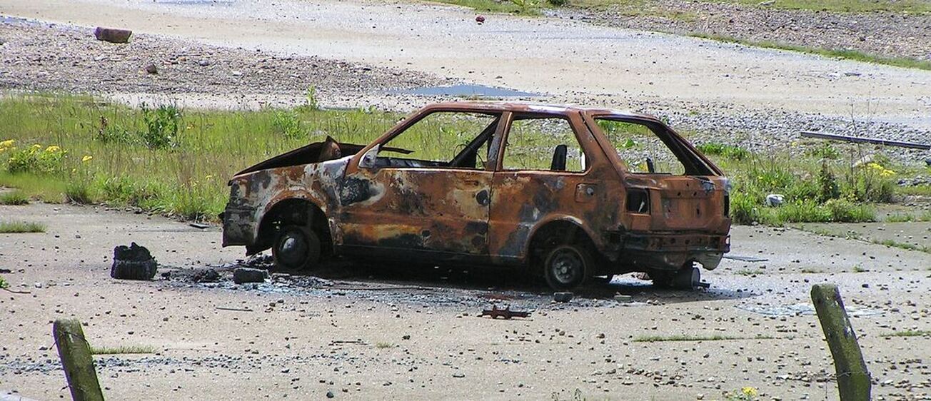 Picture of stolen, torched and abandoned car on wasteland in Belevedere, South East London