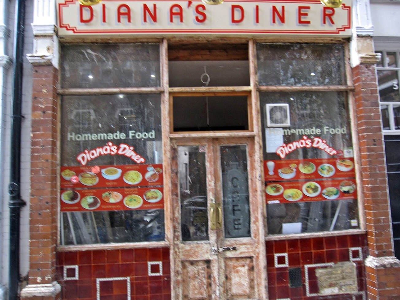 Derelict Diana's Diner in  Covent Garden with old cafe signage and builders materials inside