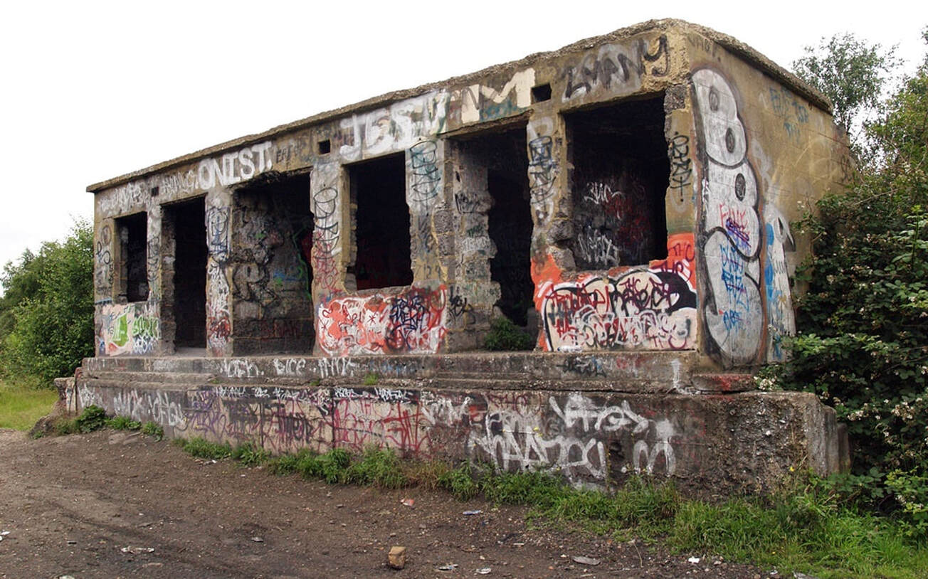 Graffiti covered abandoned concrete building at ​Feltham Rail Freight Marshalling Yard