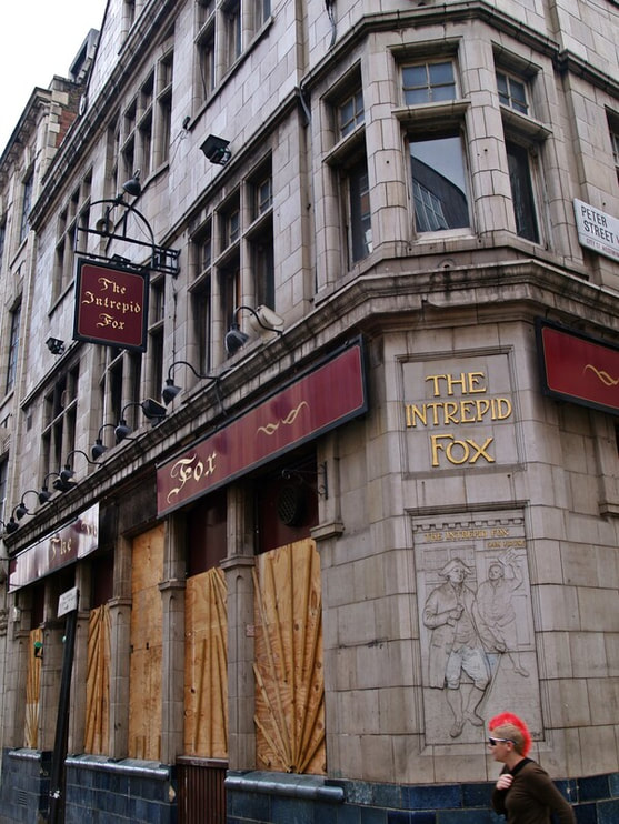 The closed down derelict Intrepid Fox pub in Wardour Street, Soho was once a rock hangout but is now a burger restaurant 