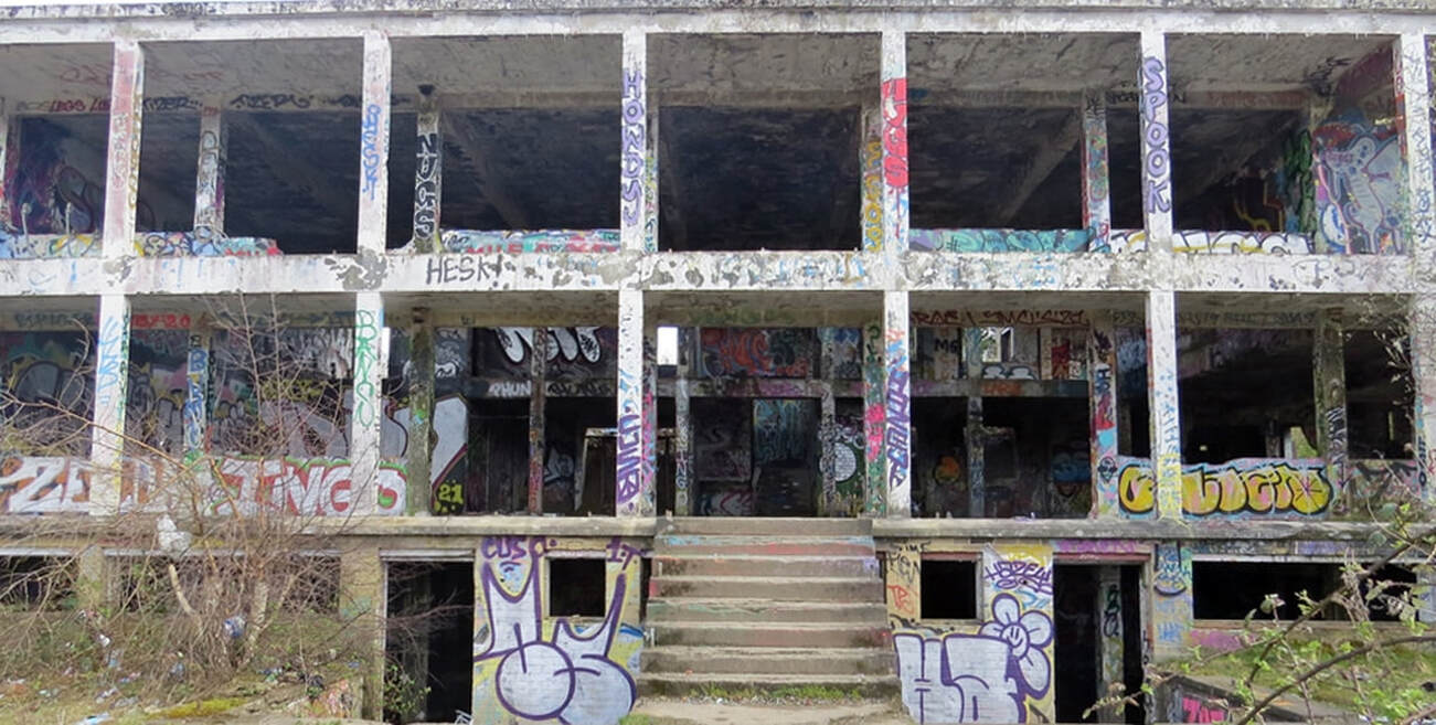 derelict concrete shell of graffiti covered abandoned sports pavilion near Staples Corner