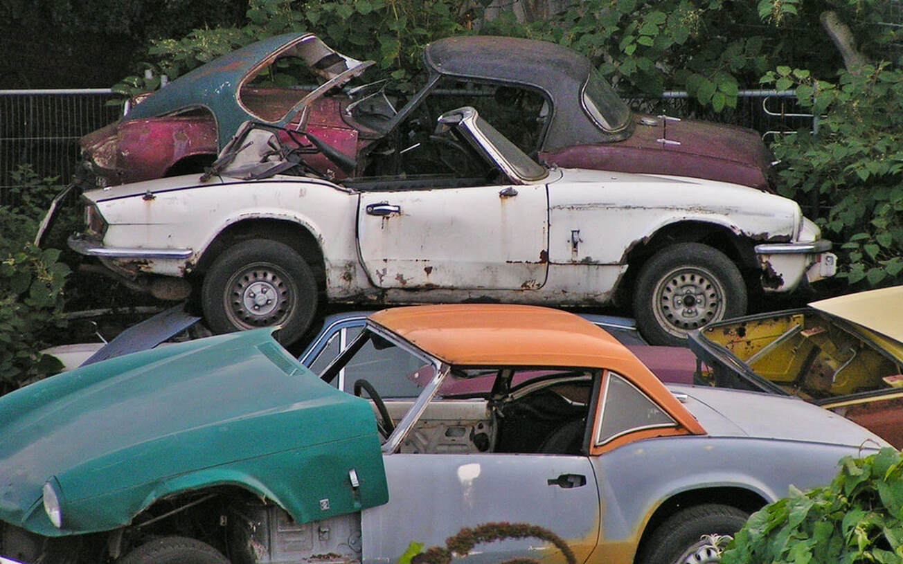 scrapped redundant Triumph Spitfires in breakers yard in South London