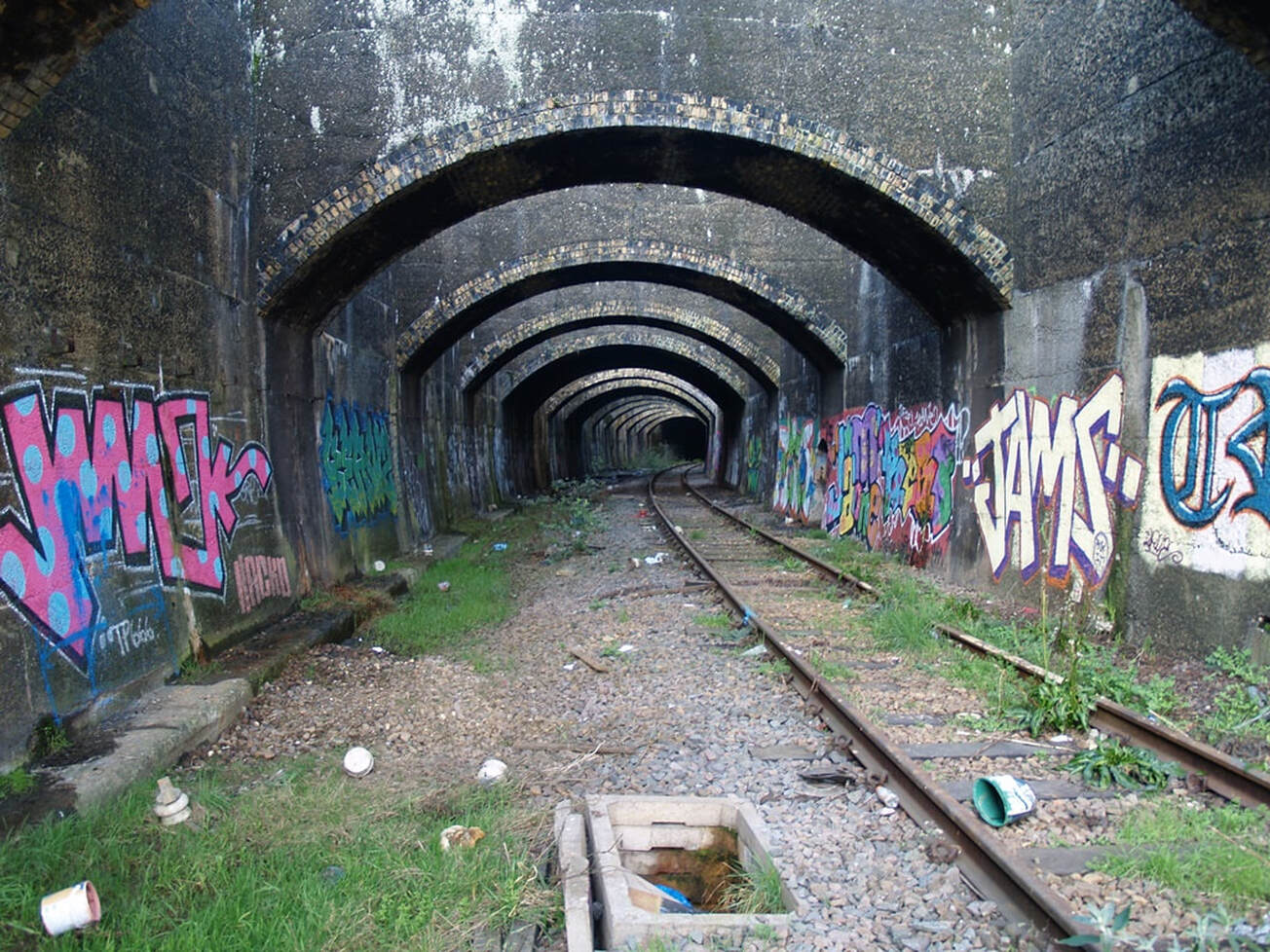 Grafiiti on the walls and disused railway in the Connaught Tunnel, viewed from Silvertown