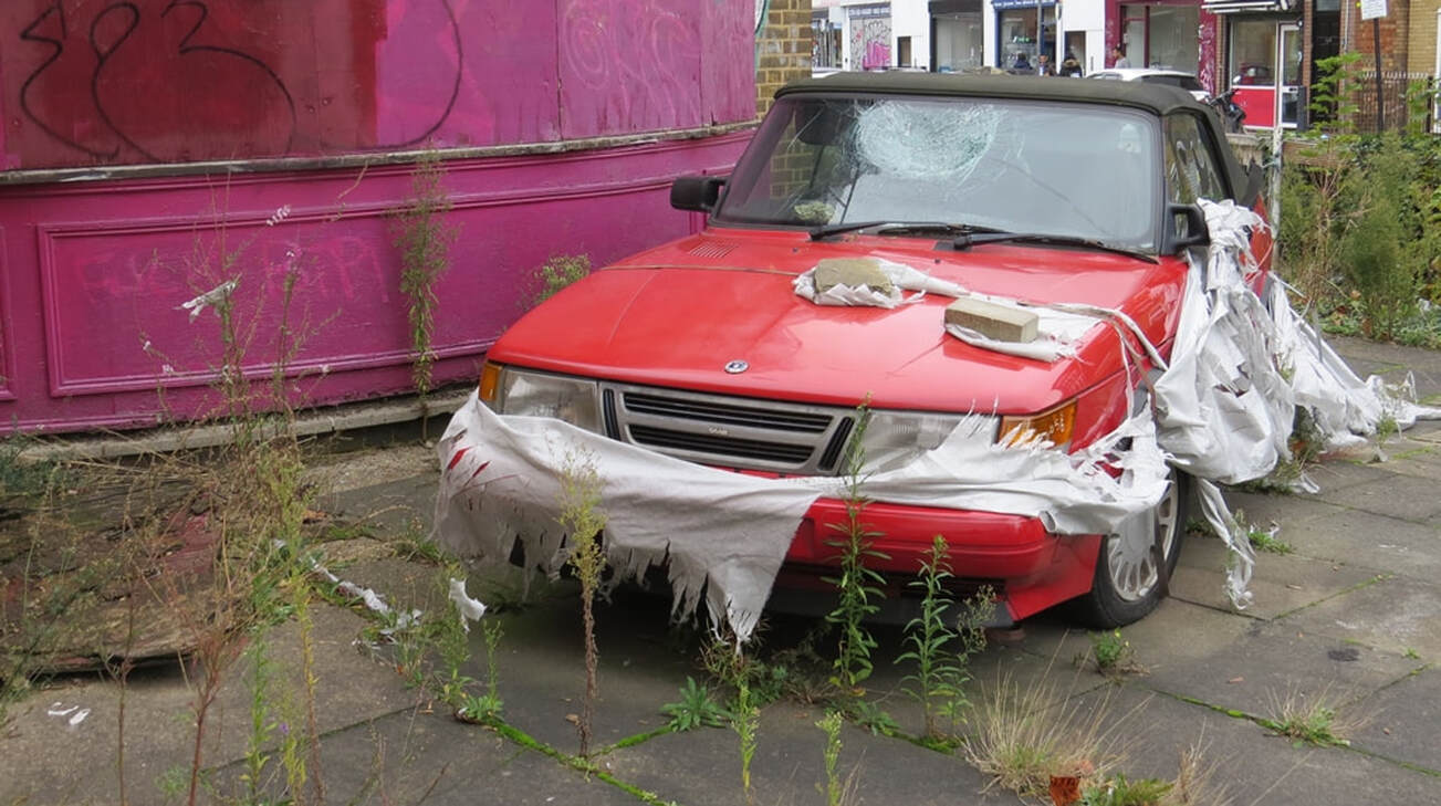 Red Saab abandoned with broken window in Stepney