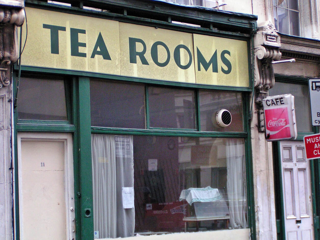 Art Deco-lettered sign for The Tea Rooms on derelict building on Museum Street in Central London