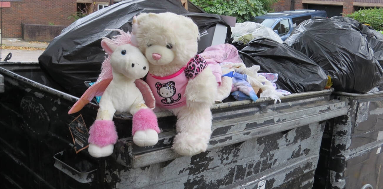 Discarded cuddly toys sitting on a refuse bin in East London 