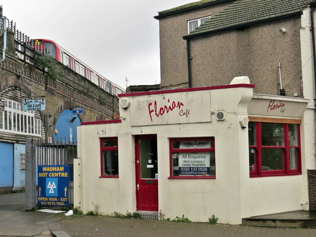 The closed down Florian Cafe next to the Tube viaduct advertised for sale in  Putney, SW15